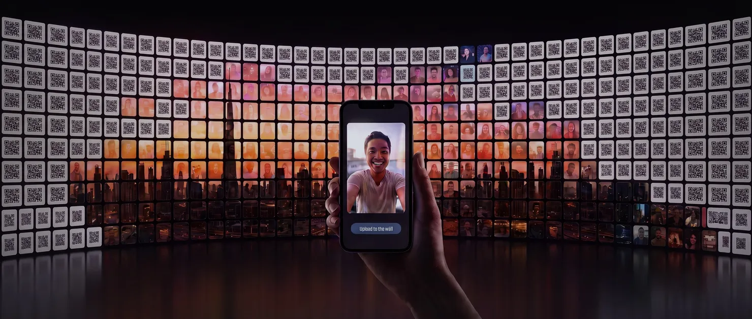 A curved wall of QR code tiles where uploaded guest selfies form a mural of the Dubai skyline, and a phone showing a selfie ready to upload