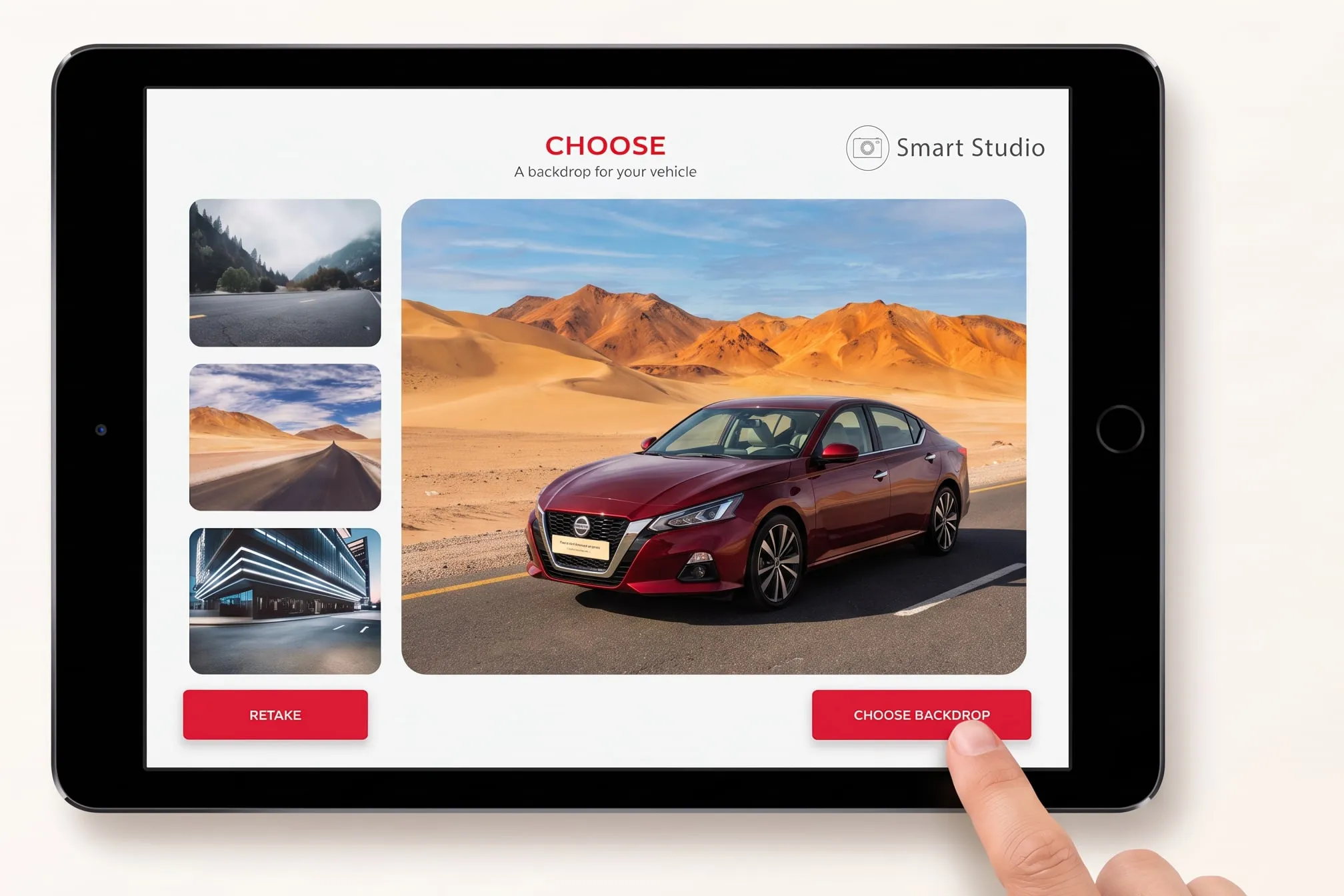 Tablet with the Smart Studio app: a red car placed on a desert road backdrop, a finger tapping Choose backdrop