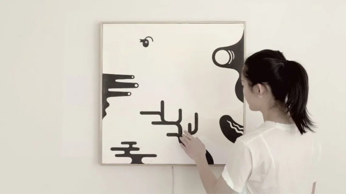 woman touching canvas with capacitive touch painting