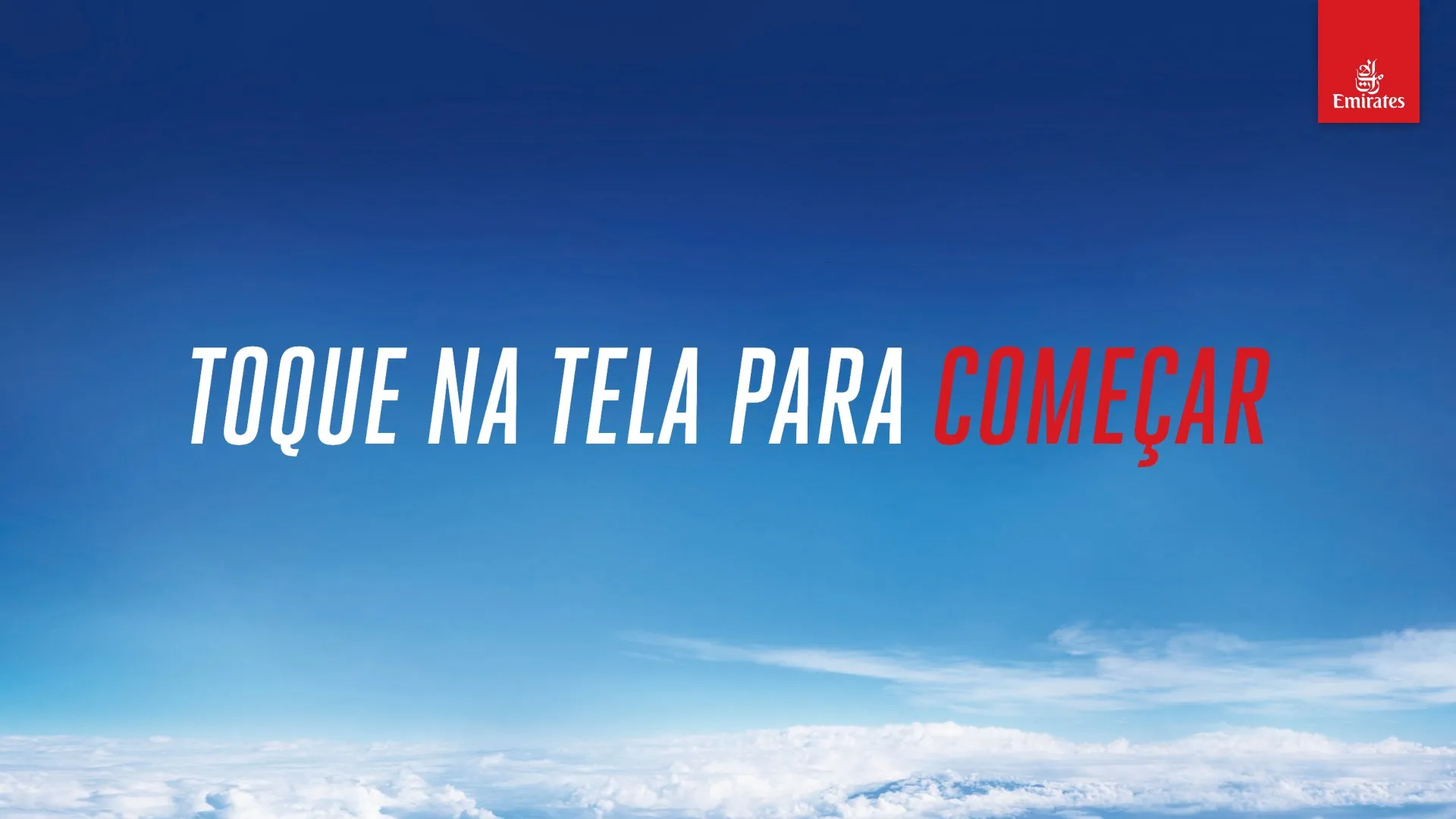 Tap-to-start attract screen with Emirates branding over a sky background