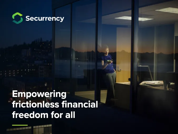Securrency logo and the headline Empowering frictionless financial freedom for all over an office window at dusk